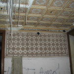 Room with coffered ceiling and graffiti, before restoration