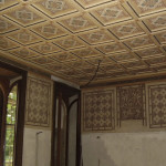 Room with coffered ceiling and graffiti, after restoration